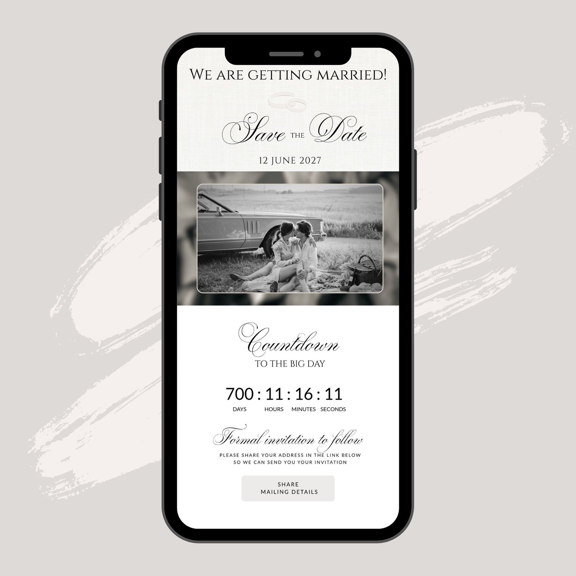 A smartphone mockup centered on a light warm-gray background, displaying a wedding save-the-date invitation design with black text, a black-and-white photo of a couple, and countdown details.