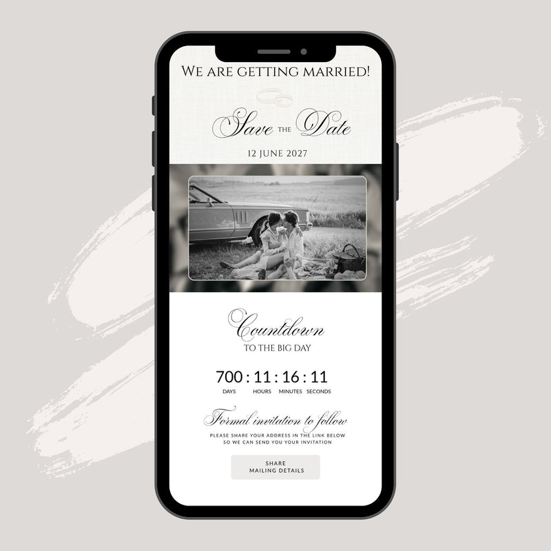 A smartphone mockup centered on a light warm-gray background, displaying a wedding save-the-date invitation design with black text, a black-and-white photo of a couple, and countdown details.