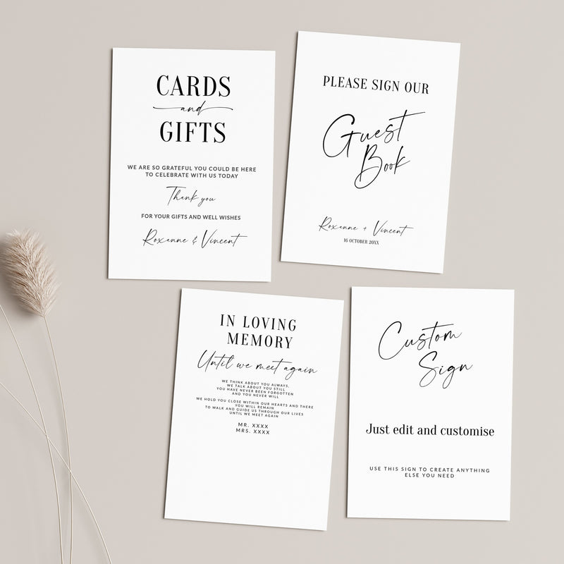 Four white wedding stationery cards with elegant black typography, arranged on a light beige background with a dried grass stem. The cards include 'Cards and Gifts', 'Please Sign Our Guest Book', 'In Loving Memory Until we part again', and 'Custom Sign'.